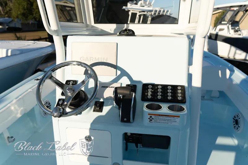 Slide: The Image of 2025 Caymas 28 HB boat console with steering wheel and controls. - 20