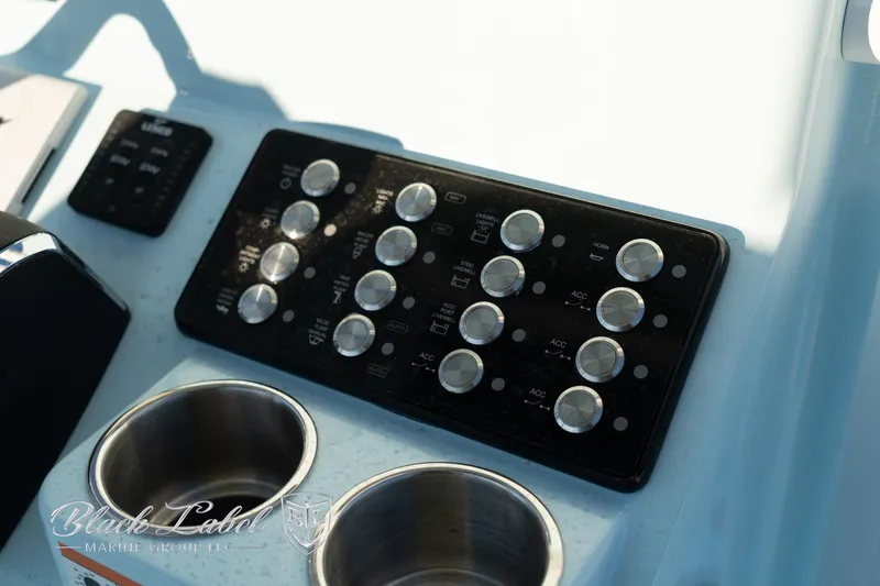 Slide: The Image of Control panel of 2025 Caymas 28 HB boat with cup holders. - 21