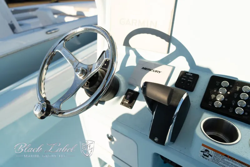 Slide: The Image of 2025 Caymas 28 HB boat helm with steering wheel and controls. - 22