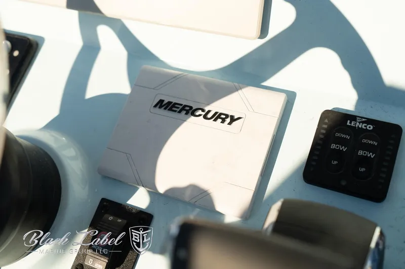 Slide: The Image of Control panel of 2025 Caymas 28 HB boat featuring Mercury and Lenco components. - 23