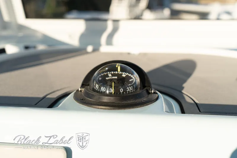 Slide: The Image of Compass on 2025 Caymas 28 HB boat dashboard, Black Label Marine Group branding. - 25