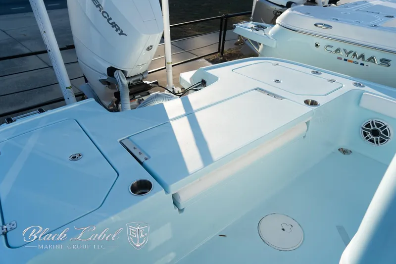 Slide: The Image of 2025 Caymas 28 HB boat deck with Mercury engine, spacious layout, and storage compartments. - 27