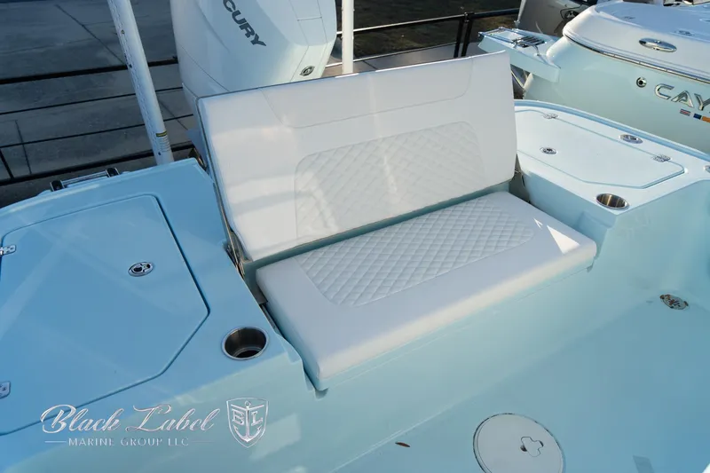 Slide: The Image of 2025 Caymas 28 HB boat with white cushioned seating and sleek design. - 28
