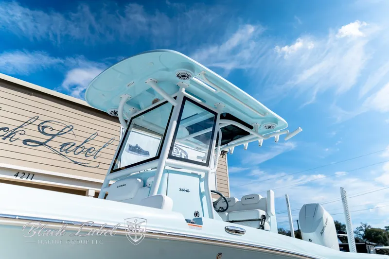 Slide: The Image of 2025 Caymas 28 HB boat with sleek design under a clear blue sky. - 3