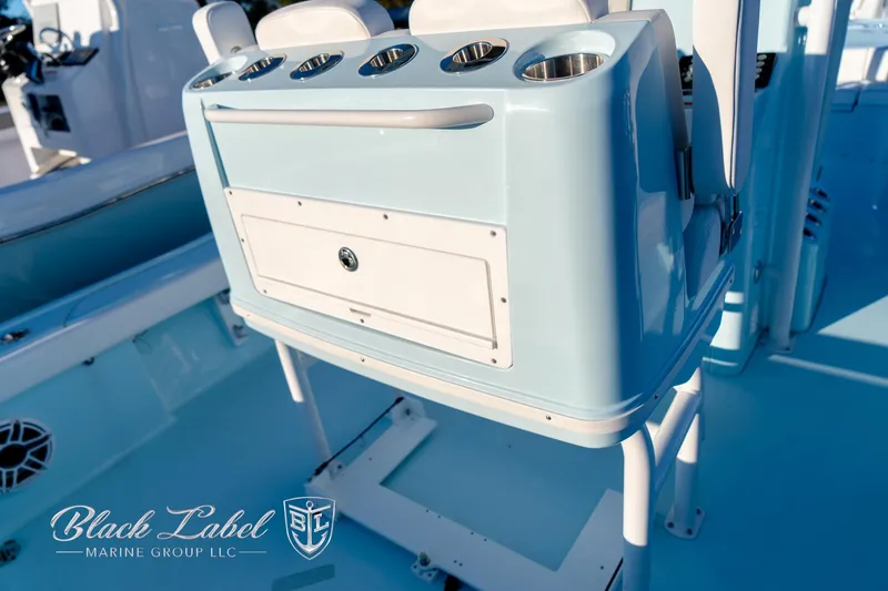 Slide: The Image of 2025 Caymas 28 HB boat interior with rod holders and storage compartment. - 30