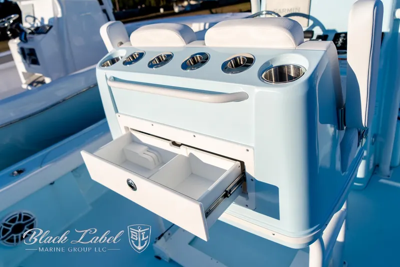 Slide: The Image of 2025 Caymas 28 HB boat interior with storage drawer and cup holders. - 31
