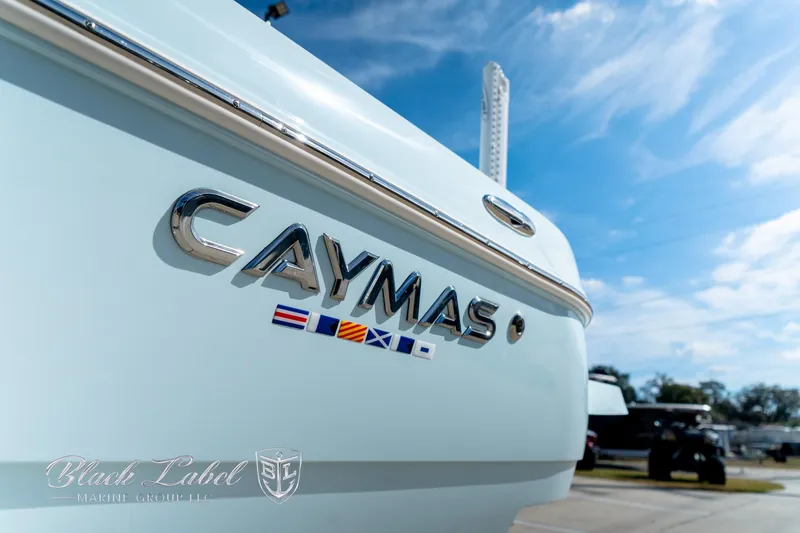 Slide: The Image of 2025 Caymas 28 HB boat with logo, clear sky background. - 4