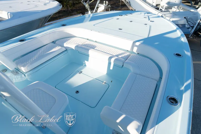 Slide: The Image of 2025 Caymas 28 HB boat interior with white seating and storage compartments. - 7
