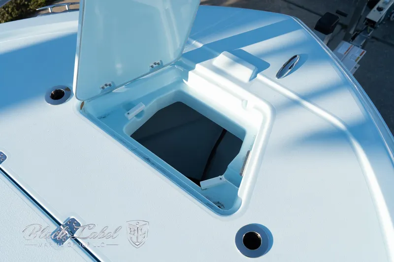 Slide: The Image of Open hatch on 2025 Caymas 28 HB boat deck, showcasing storage compartment. - 9