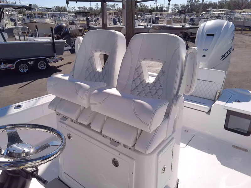 Slide: The Image of 2025 Sportsman Masters 267OE Bay Boat with luxurious white seating and steering wheel. - 10