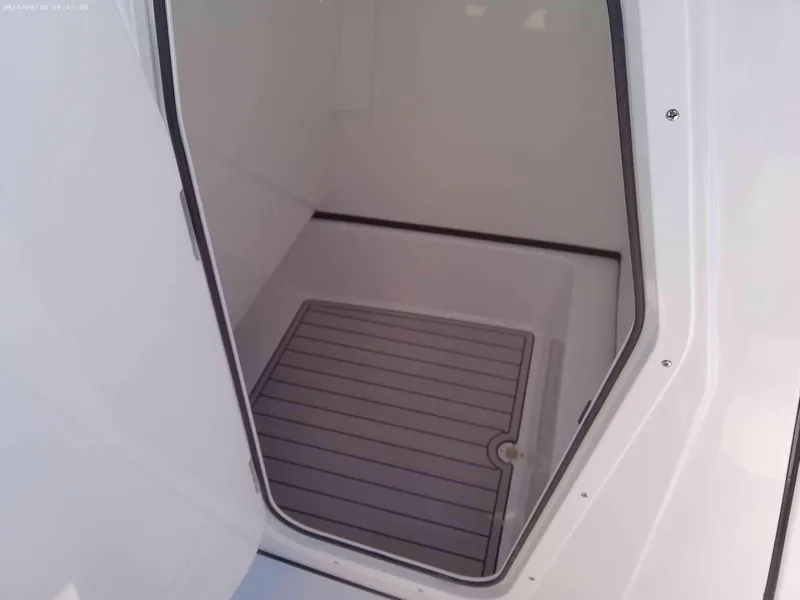 Slide: The Image of 2025 Sportsman Masters 267OE Bay Boat interior compartment with non-slip flooring. - 11