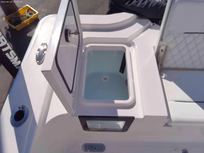 Slide: The Image of 2025 Sportsman Masters 267OE Bay Boat livewell with open lid, showcasing interior. - 12