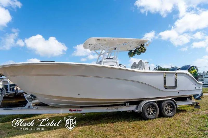 Slide: The Image of 2023 Sea Fox 288 Commander boat on trailer under blue sky. - 10