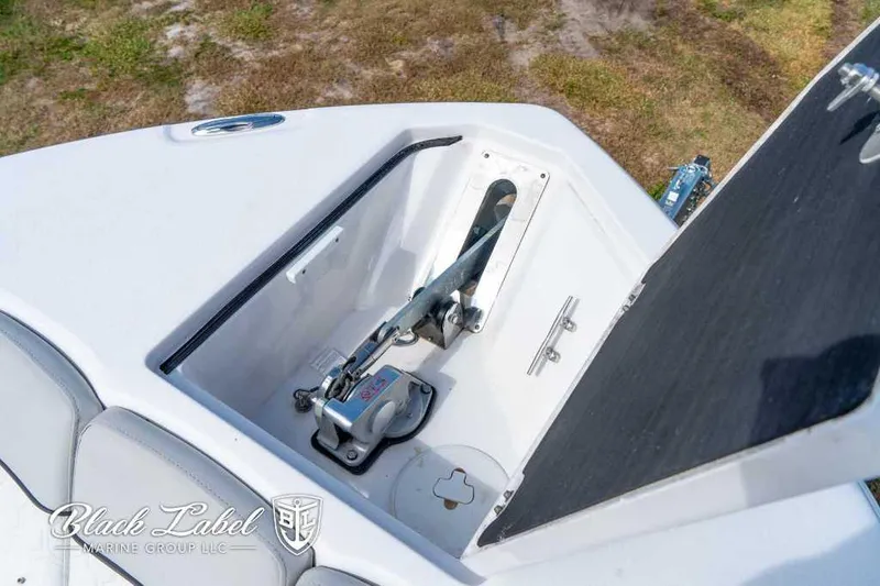 Slide: The Image of 2023 Sea Fox 288 Commander anchor compartment, open lid, Black Label Marine Group branding. - 16