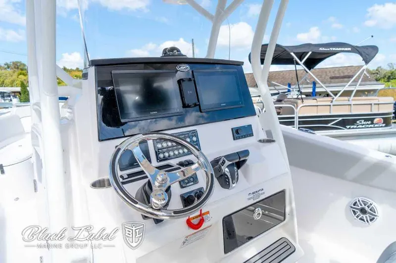 Slide: The Image of 2023 Sea Fox 288 Commander boat dashboard with steering wheel and navigation screens. - 21