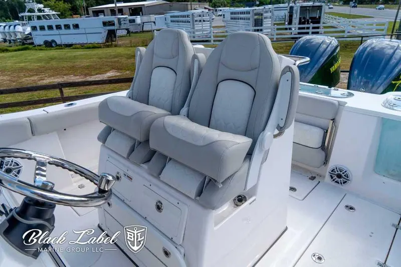 Slide: The Image of 2023 Sea Fox 288 Commander boat interior with dual captain's chairs and steering wheel. - 22