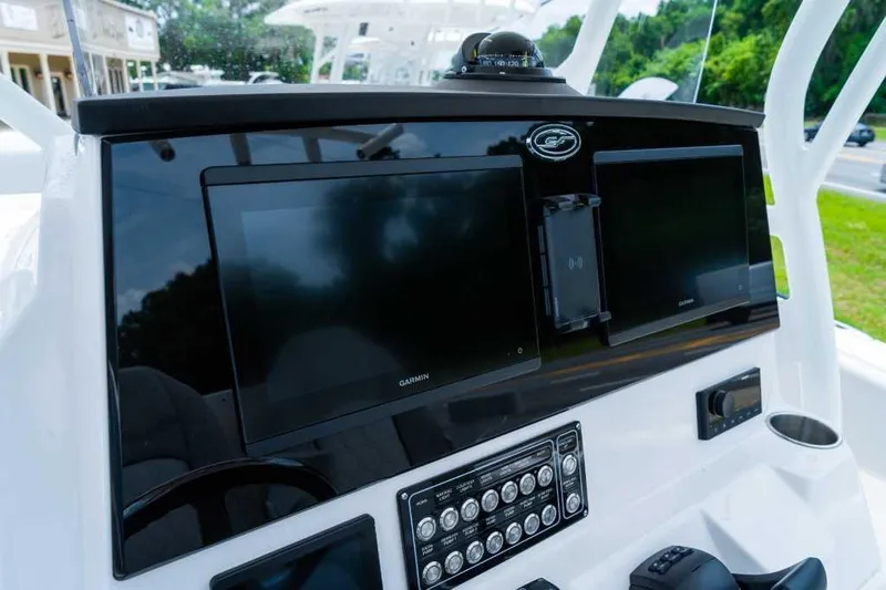 Slide: The Image of 2023 Sea Fox 288 Commander dashboard with dual Garmin displays and control panel. - 4