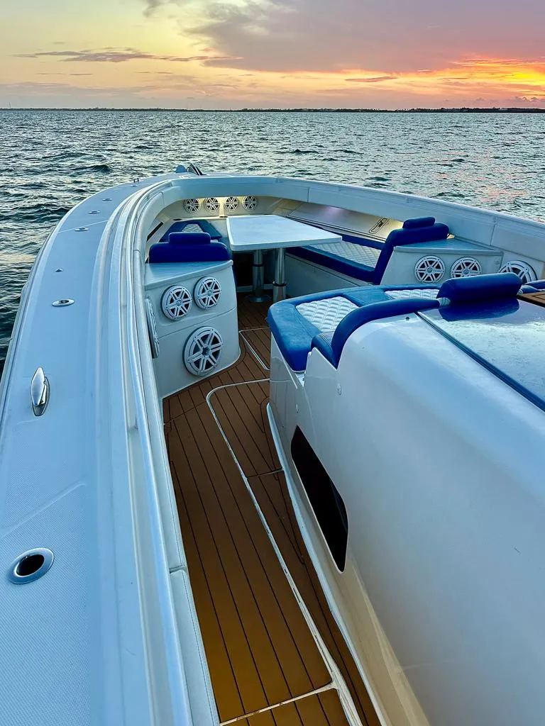 Slide: The Image of 2018 HCB 53 Suenos RXV boat with sunset view, featuring sleek design and spacious deck. - 10