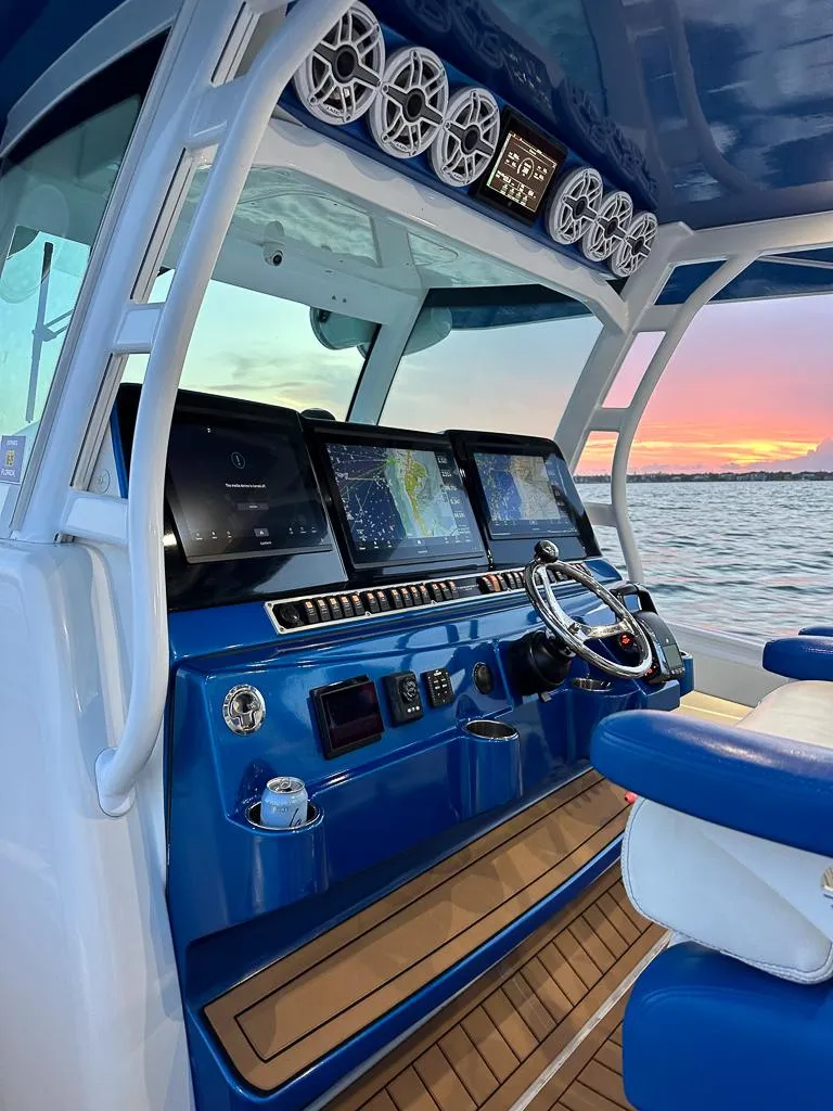 Slide: The Image of 2018 HCB 53 Suenos RXV boat interior with advanced navigation system at sunset. - 5