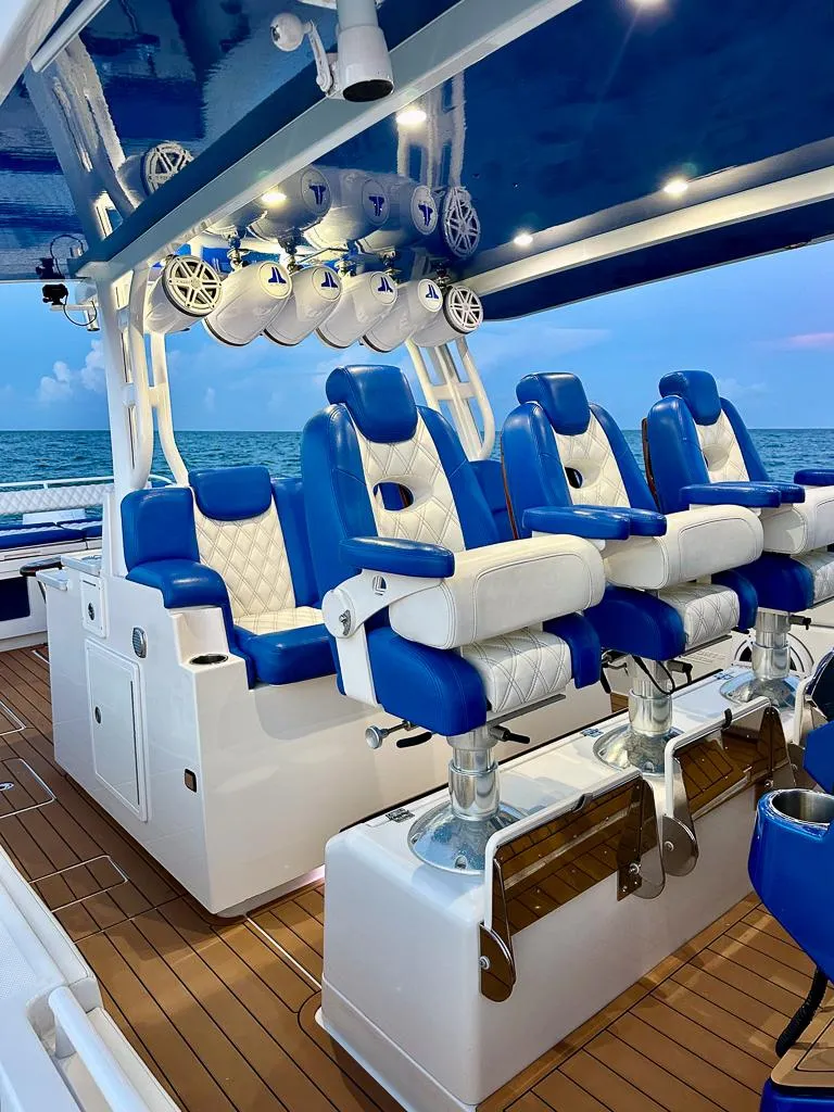 Slide: The Image of 2018 HCB 53 Suenos RXV luxury boat with blue and white seating, ocean backdrop. - 3
