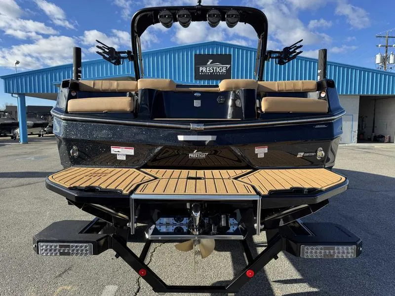 Slide: The Image of 2025 MasterCraft XT24 boat rear view with teak deck and seating. - 3