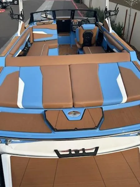 Slide: The Image of 2025 Axis T220 boat with blue and brown interior, featuring spacious seating and modern design. - 12
