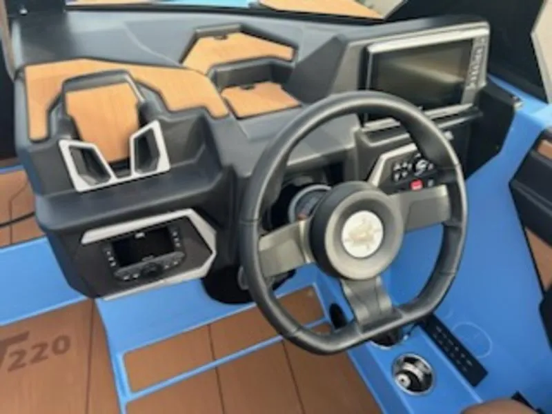 Slide: The Image of 2025 Axis T220 boat dashboard with steering wheel and digital display. - 14