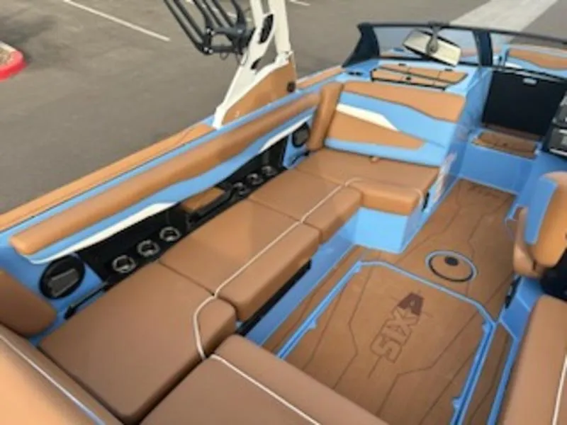 Slide: The Image of 2025 Axis T220 boat interior with tan and blue seating, modern design. - 16