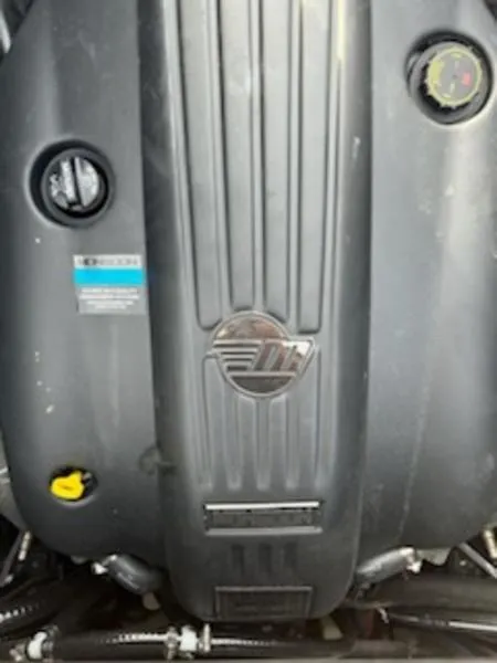 Slide: The Image of 2025 Axis T220 engine cover with logo and components. - 3