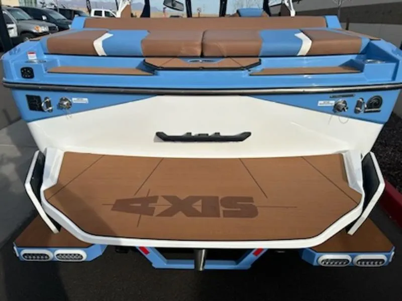 Slide: The Image of 2025 Axis T220 boat, blue and white, rear view with logo on deck. - 6