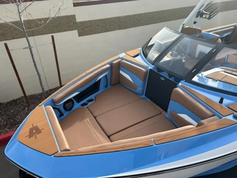 Slide: The Image of 2025 Axis T220 boat with blue exterior and tan interior seating. - 9