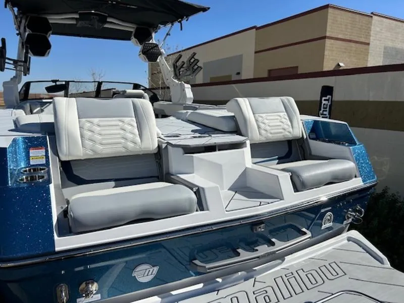 Slide: The Image of 2025 Malibu 26 LSV boat with luxurious seating and sleek design. - 10