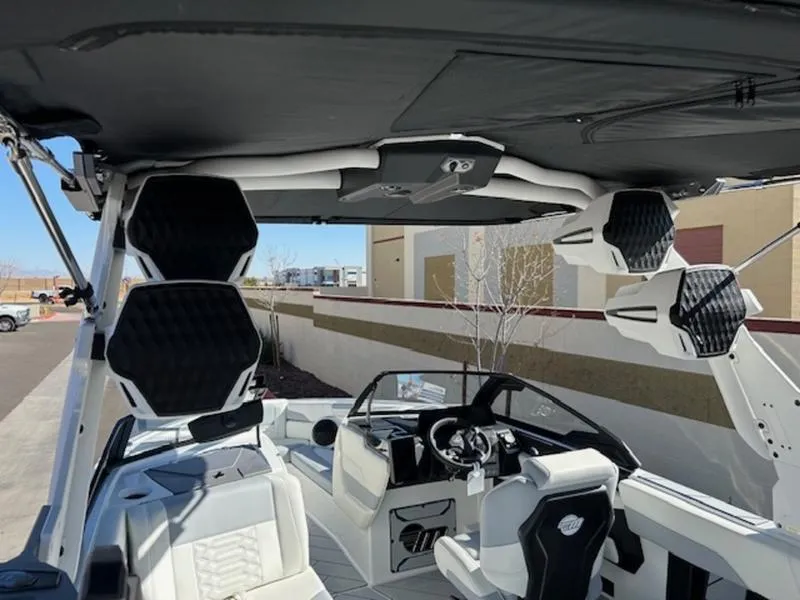 Slide: The Image of 2025 Malibu 26 LSV boat interior with modern seating and advanced audio system. - 11