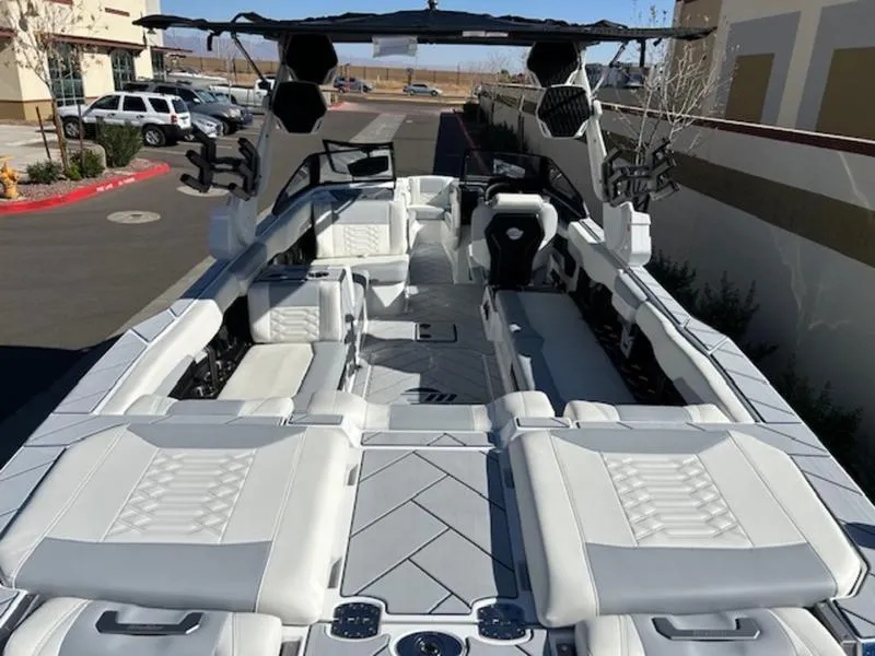 Slide: The Image of 2025 Malibu 26 LSV boat with luxurious white interior and modern design. - 12
