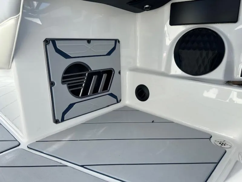 Slide: The Image of 2025 Malibu 26 LSV boat interior with speaker and sleek design. - 16