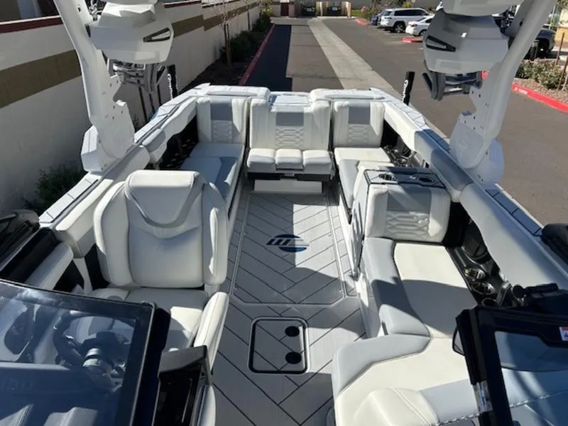 Slide: The Image of 2025 Malibu 26 LSV boat interior with luxurious white seating and modern design. - 20