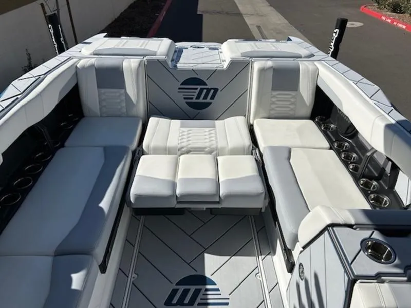 Slide: The Image of 2025 Malibu 26 LSV boat interior with luxurious white seating and modern design. - 21
