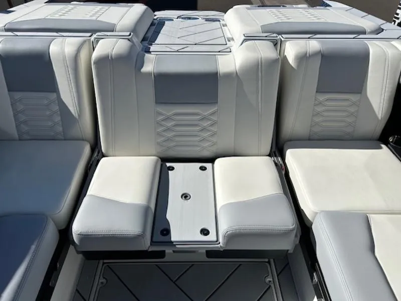 Slide: The Image of 2025 Malibu 26 LSV boat interior with luxurious white and gray seating. - 22