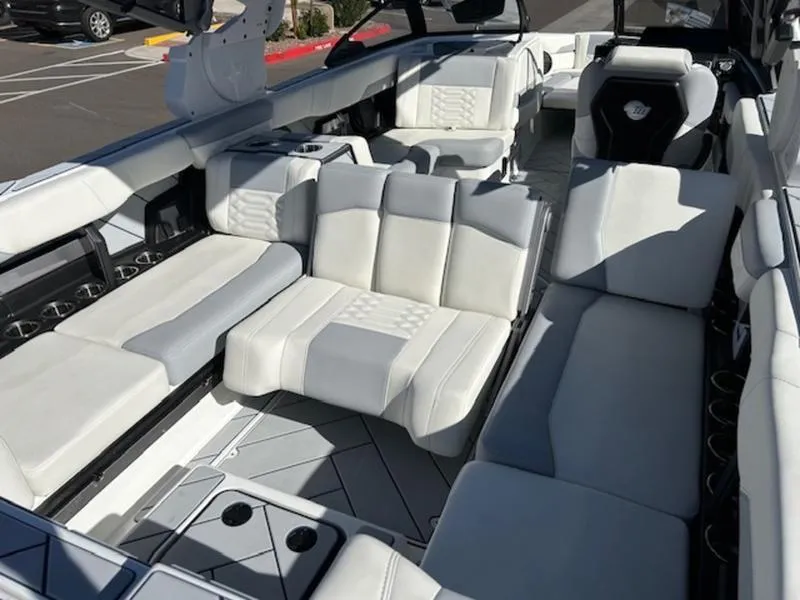 Slide: The Image of 2025 Malibu 26 LSV boat interior with luxurious white seating and modern design. - 24