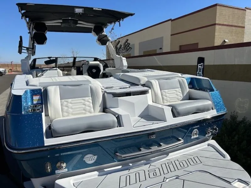 Slide: The Image of 2025 Malibu 26 LSV boat with luxurious seating and sleek design. - 9