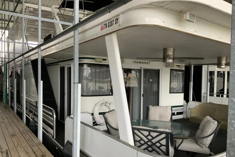 The Image of 2004 Sumerset 18 x 87 houseboat with outdoor seating on a dock. - 0