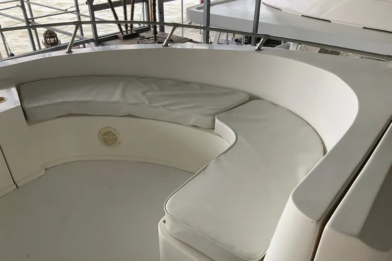 Slide: The Image of 2004 Sumerset 18 x 87 boat seating area with white cushions. - 11