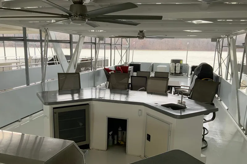 Slide: The Image of Spacious 2004 Sumerset 18 x 87 houseboat deck with seating and bar area. - 18