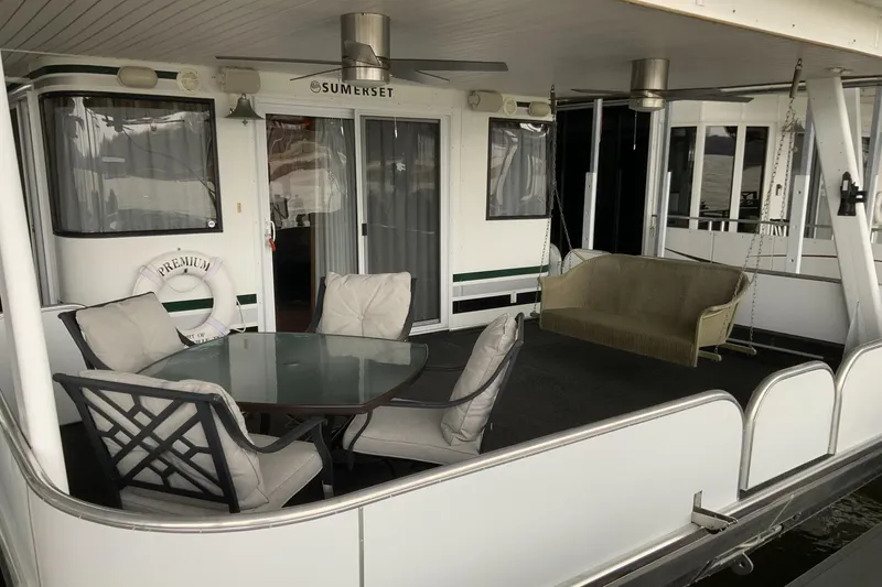 Slide: The Image of 2004 Sumerset 18 x 87 houseboat with outdoor seating and glass table on deck. - 2