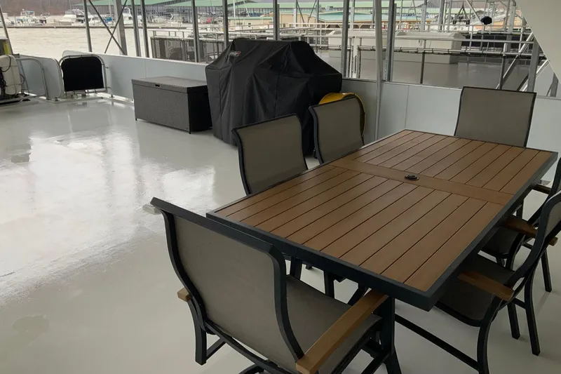 Slide: The Image of Spacious deck on 2004 Sumerset 18 x 87 houseboat with outdoor dining set. - 21