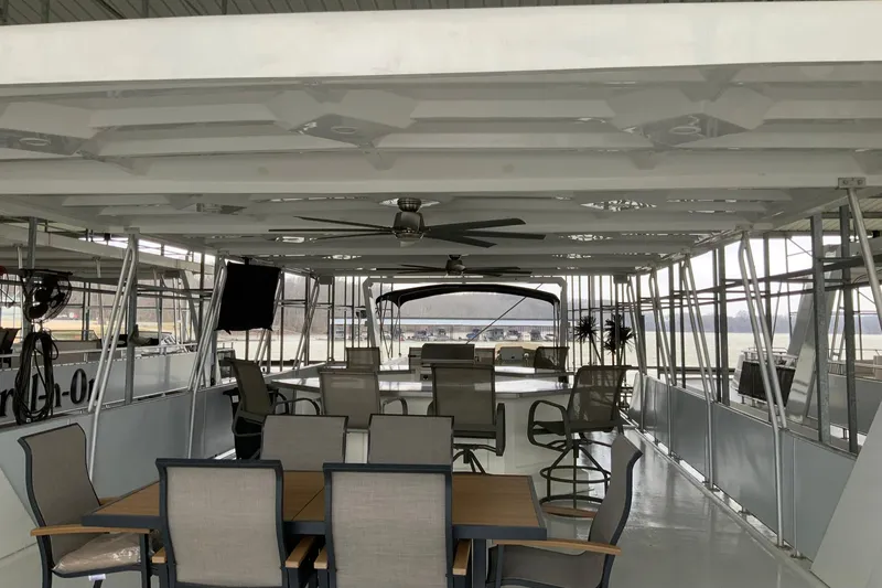 Slide: The Image of Spacious 2004 Sumerset 18 x 87 houseboat interior with seating and ceiling fan. - 27