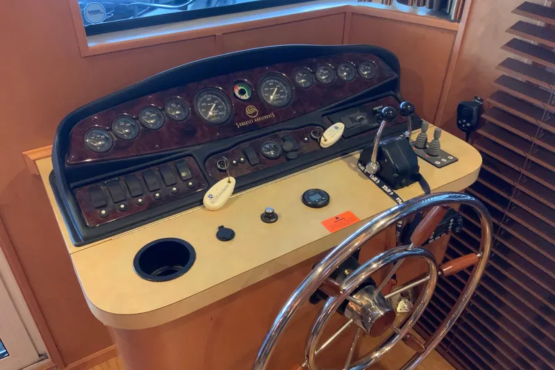 Slide: The Image of Control panel of a 2004 Sumerset 18 x 87 houseboat with steering wheel and gauges. - 33