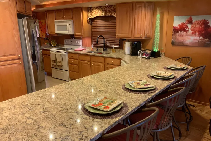 Slide: The Image of Luxurious kitchen in 2004 Sumerset 18 x 87 houseboat with granite countertops and wooden cabinetry. - 34