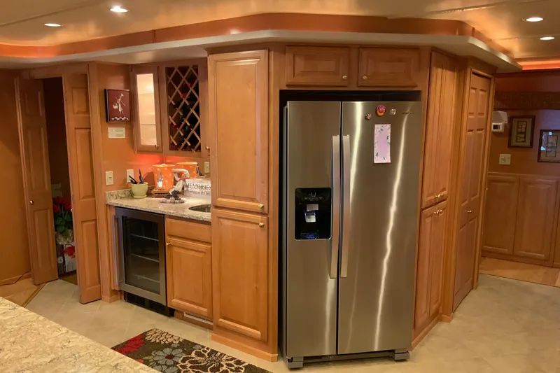 Slide: The Image of Luxurious kitchen in 2004 Sumerset 18 x 87 houseboat with stainless steel appliances and wooden cabinetry. - 36