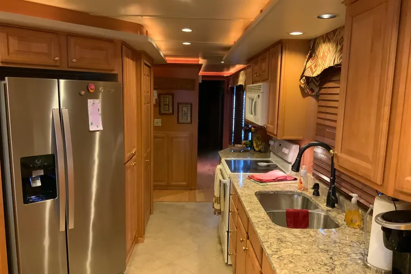 Slide: The Image of Luxurious kitchen in 2004 Sumerset 18 x 87 houseboat with granite countertops and stainless steel appliances. - 37